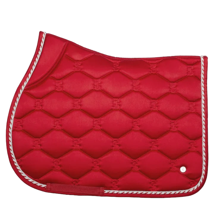 Red quilted saddle pad with white trim on a white background